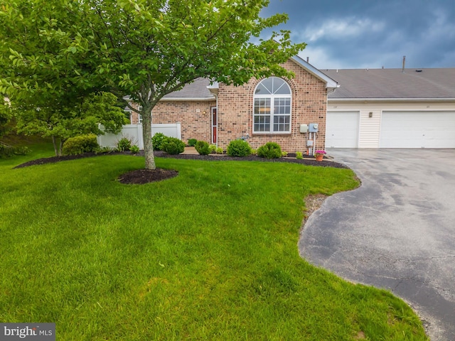 view of front of house with driveway, an attached garage, and brick siding