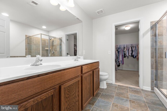 27 Hopkins Branch Way, Fredericksburg, VA 22406 - bathroom featuring a spacious closet, a shower stall, double vanity, and stone finish floors