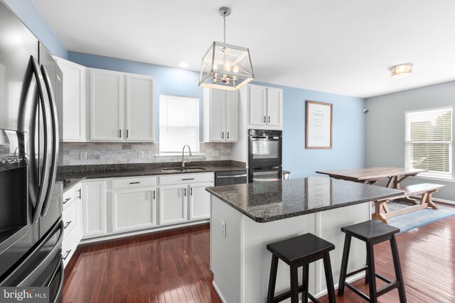 27 Hopkins Branch Way, Fredericksburg, VA 22406 - kitchen with refrigerator with ice dispenser, a kitchen bar, a chandelier, dishwasher, and white cabinets