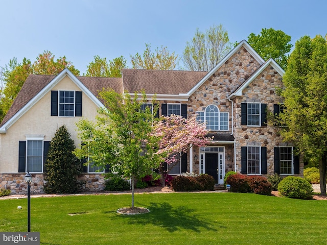 1711 Butternut Cir, West Chester, PA 19382 - view of front of home with stone siding, a front yard, and a shingled roof