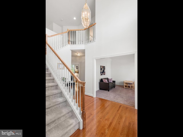 1711 Butternut Cir, West Chester, PA 19382 - stairs featuring a chandelier, wood finished floors, baseboards, a high ceiling, and recessed lighting