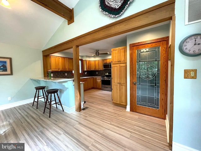 8408 Alvin Rd, Pasadena, MD 21122 - kitchen with appliances with stainless steel finishes, a peninsula, tasteful backsplash, brown cabinets, and a breakfast bar