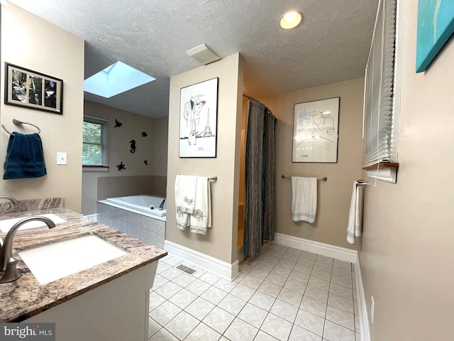 8408 Alvin Rd, Pasadena, MD 21122 - bathroom with a skylight, a textured ceiling, a garden tub, vanity, and baseboards
