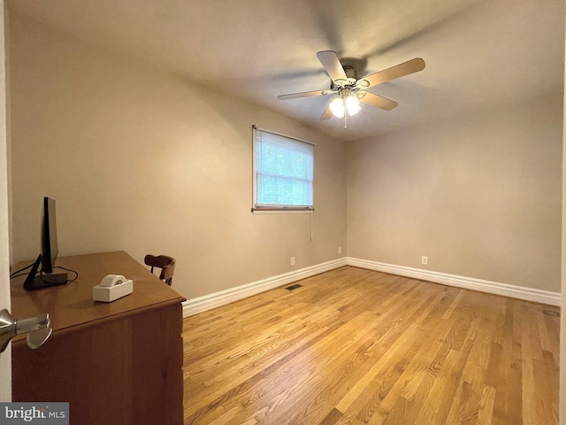 8408 Alvin Rd, Pasadena, MD 21122 - empty room featuring baseboards, light wood-type flooring, a desk, and a ceiling fan