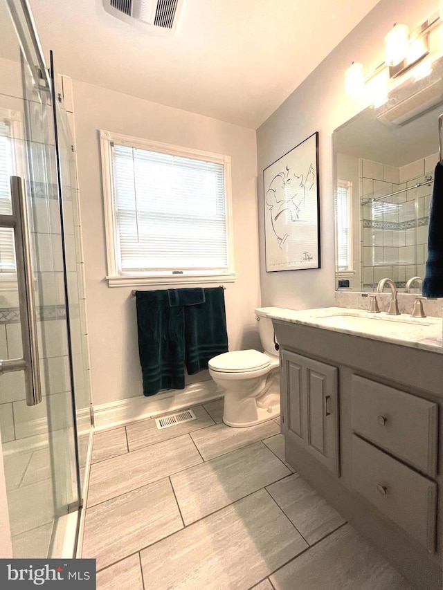 8408 Alvin Rd, Pasadena, MD 21122 - bathroom with a shower stall, vanity, and toilet