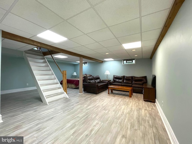 8408 Alvin Rd, Pasadena, MD 21122 - living area with wood finished floors, a paneled ceiling, baseboards, and stairway