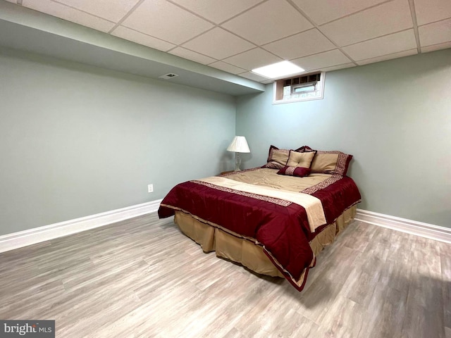8408 Alvin Rd, Pasadena, MD 21122 - bedroom with wood finished floors, baseboards, and a drop ceiling