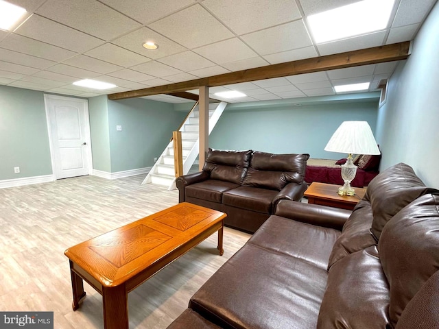 8408 Alvin Rd, Pasadena, MD 21122 - living area featuring wood finished floors, a paneled ceiling, baseboards, and stairway