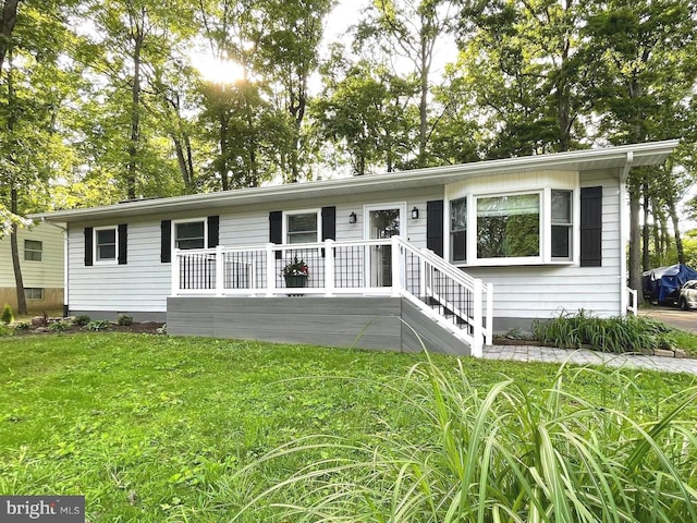 8408 Alvin Rd, Pasadena, MD 21122 - view of front of property featuring a front lawn and a wooden deck