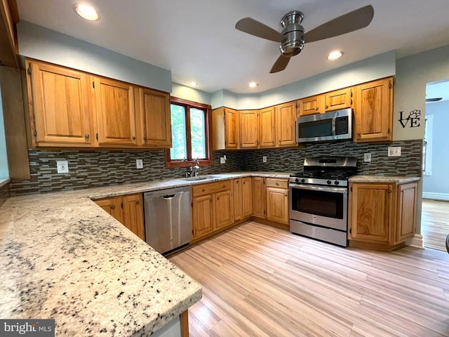8408 Alvin Rd, Pasadena, MD 21122 - kitchen featuring stainless steel appliances, a ceiling fan, brown cabinets, and light wood-style flooring