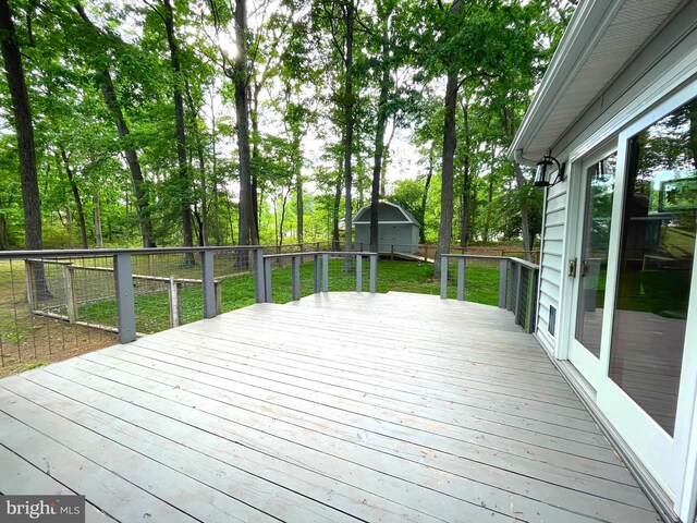 8408 Alvin Rd, Pasadena, MD 21122 - wooden deck with a shed and an outbuilding