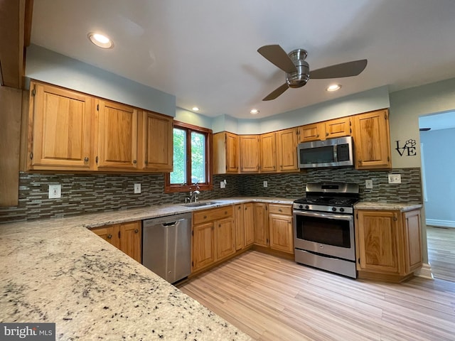 8408 Alvin Rd, Pasadena, MD 21122 - kitchen with appliances with stainless steel finishes, light wood finished floors, tasteful backsplash, a ceiling fan, and recessed lighting