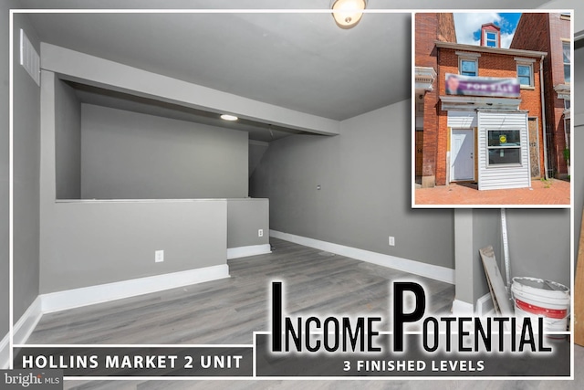 below grade area featuring baseboards and wood finished floors