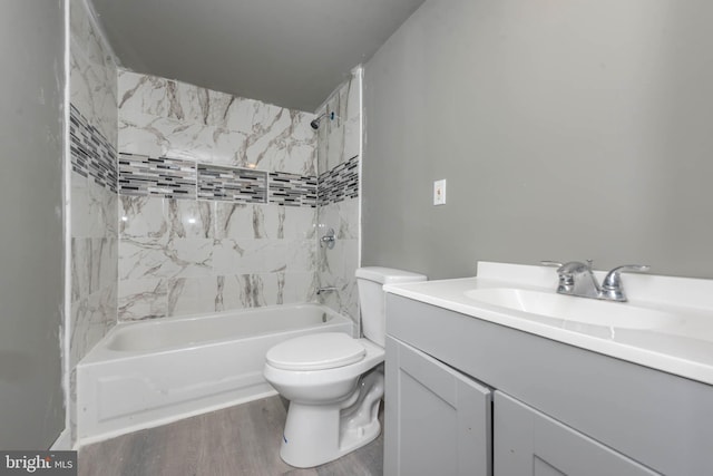 full bathroom featuring wood finished floors, toilet, vanity, and shower / tub combination