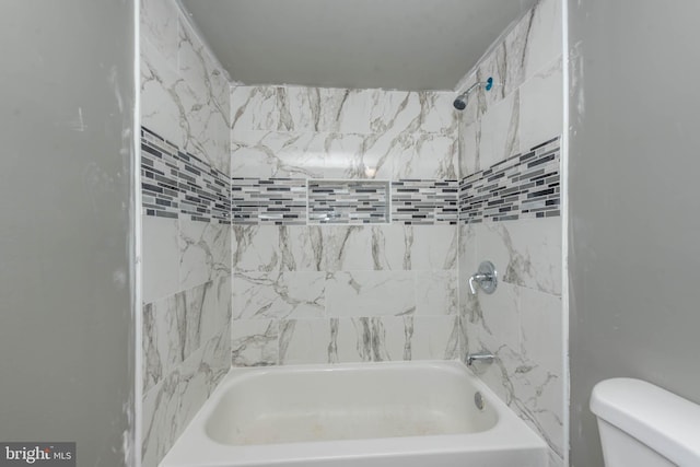 bathroom featuring toilet and bathing tub / shower combination