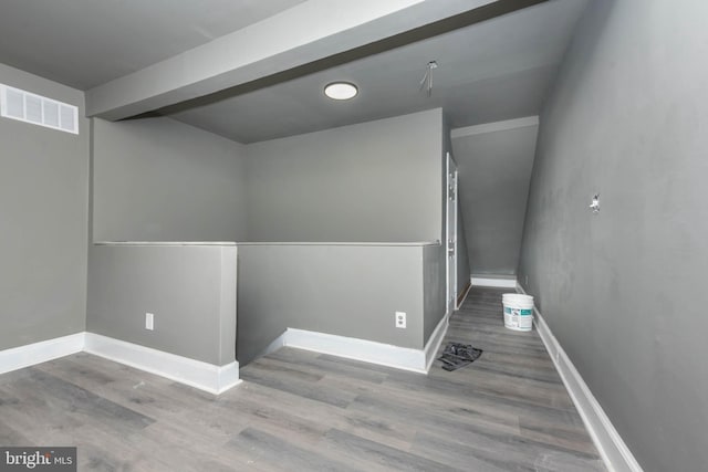 spare room featuring wood finished floors and baseboards
