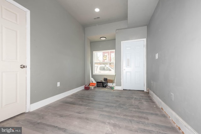 spare room with wood finished floors and baseboards