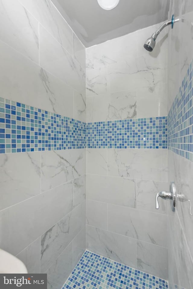 bathroom with tiled shower