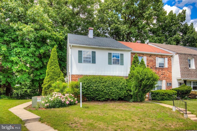 320 Bala Ter W, West Chester, PA 19380 - view of front of house featuring a chimney, a front yard, and brick siding