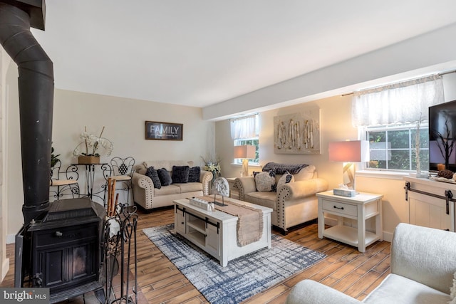 320 Bala Ter W, West Chester, PA 19380 - living area with a wood stove, plenty of natural light, and wood finished floors