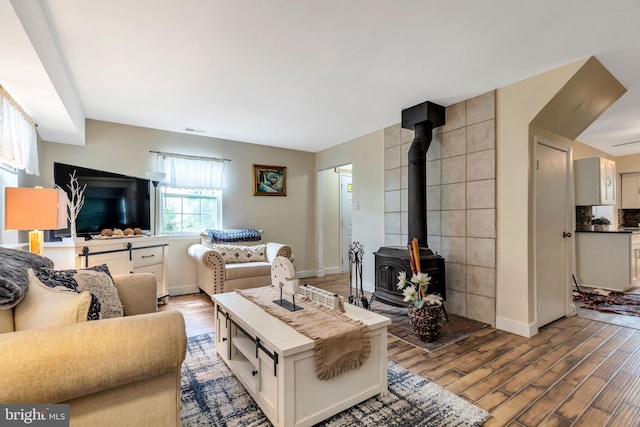 320 Bala Ter W, West Chester, PA 19380 - living area with wood finished floors, a wood stove, and baseboards
