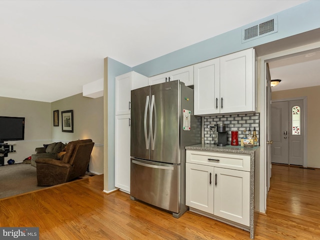 24129 Pecan Grove Ln, Gaithersburg, MD 20882 - kitchen with freestanding refrigerator, white cabinetry, light wood-style flooring, and backsplash