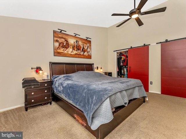 24129 Pecan Grove Ln, Gaithersburg, MD 20882 - carpeted bedroom with a barn door, baseboards, a walk in closet, and a ceiling fan