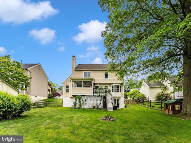 24129 Pecan Grove Ln, Gaithersburg, MD 20882 - back of property with stairway, a chimney, an outdoor fire pit, and a sunroom