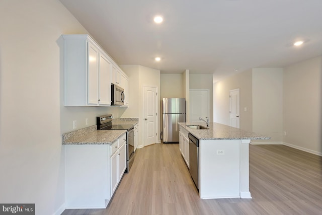 24 Cramsford St, Falling Waters, WV 25419 - kitchen featuring stainless steel appliances, a sink, light wood-style floors, baseboards, and white cabinetry