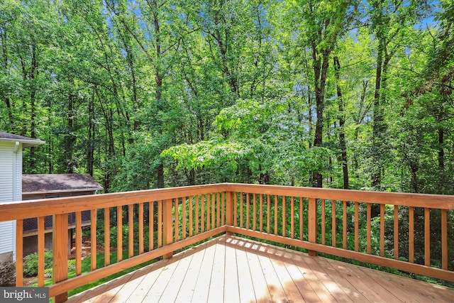 wooden deck featuring a forest view