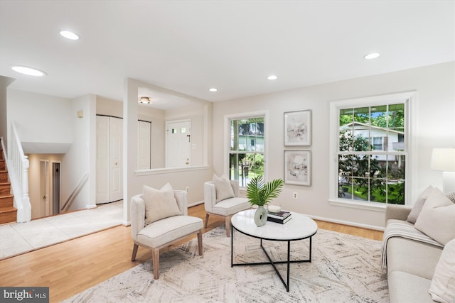 living area featuring stairway, wood finished floors, recessed lighting, and baseboards