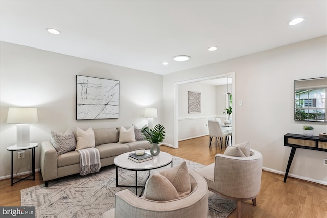 living area with light wood finished floors, recessed lighting, and baseboards