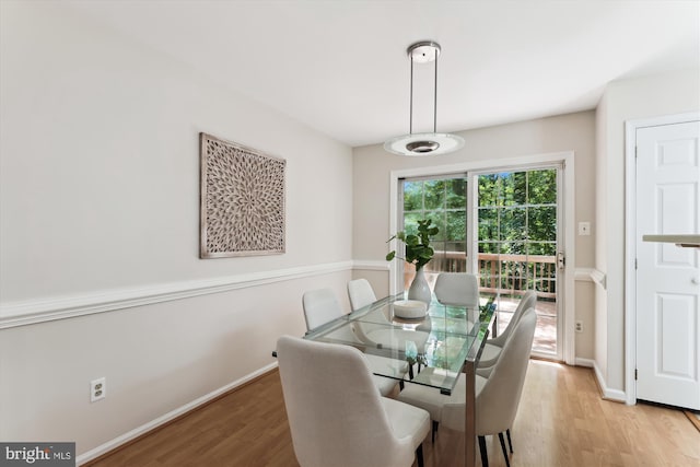 dining area with light wood-style floors and baseboards