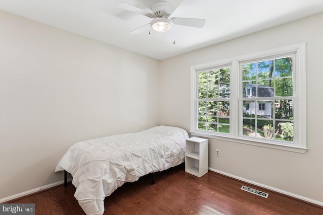 bedroom with baseboards, wood finished floors, and a ceiling fan