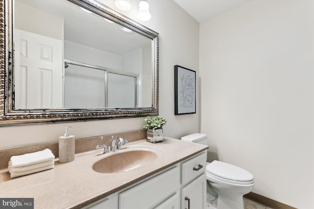 full bath with a shower stall, toilet, and vanity