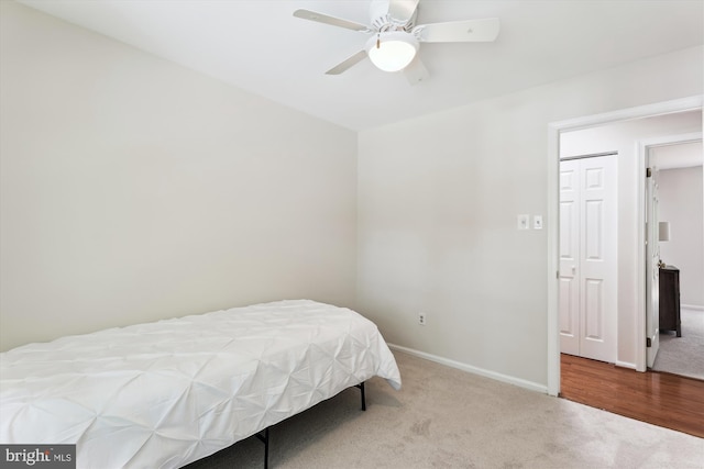 carpeted bedroom featuring baseboards and ceiling fan