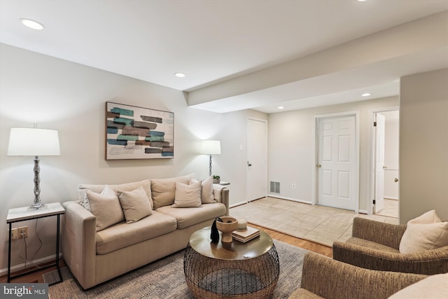 living room with recessed lighting, light wood-style floors, and baseboards