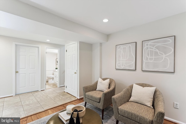 living area with baseboards, recessed lighting, and light wood finished floors