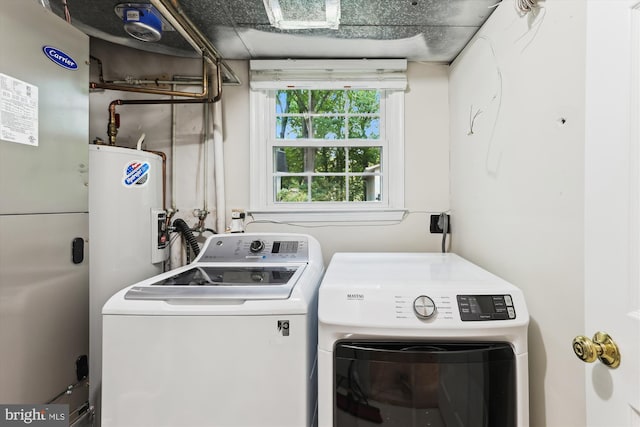laundry area with washer and dryer and electric water heater