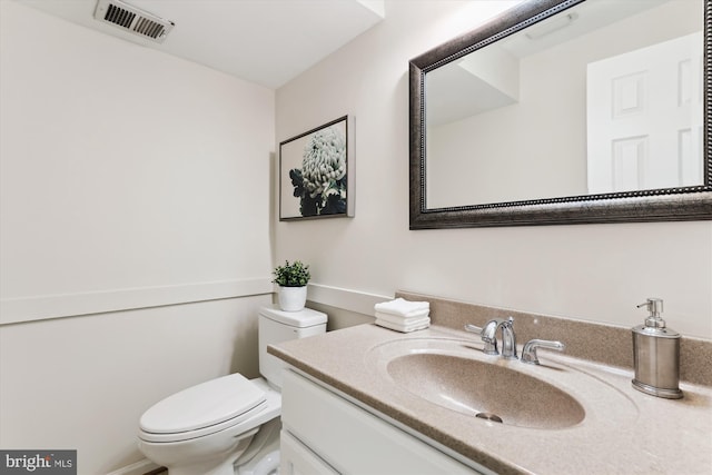bathroom featuring toilet and vanity