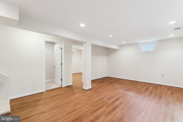 basement with light wood-style floors, baseboards, and recessed lighting
