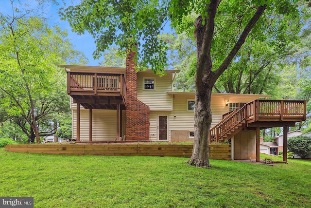 back of property featuring a lawn, a wooden deck, a chimney, and stairs