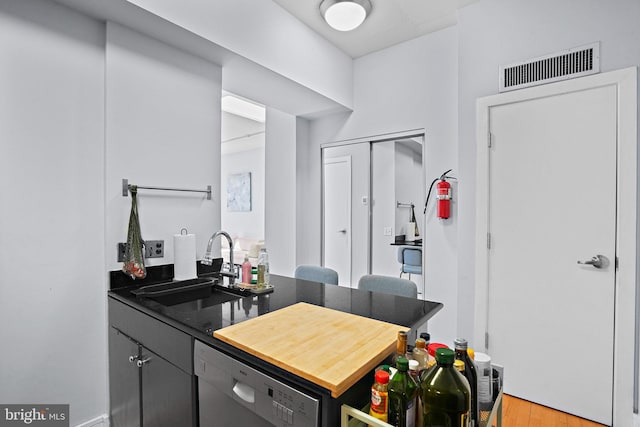809 6th St NW Unit 63, Washington, DC 20001 - kitchen featuring dishwasher, light wood-style flooring, and a peninsula
