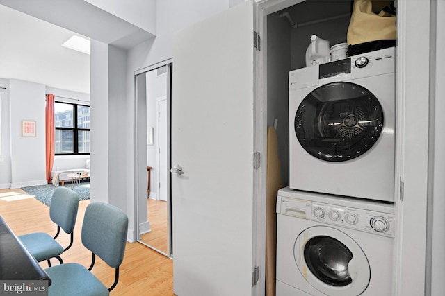 809 6th St NW Unit 63, Washington, DC 20001 - laundry area featuring stacked washer / drying machine and light wood-style flooring