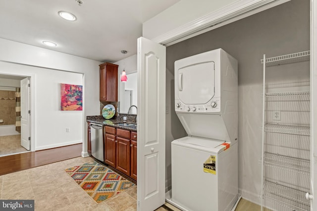 400 Cameron Station Blvd Unit 417, Alexandria, VA 22304 - laundry area with stacked washing machine and dryer and baseboards