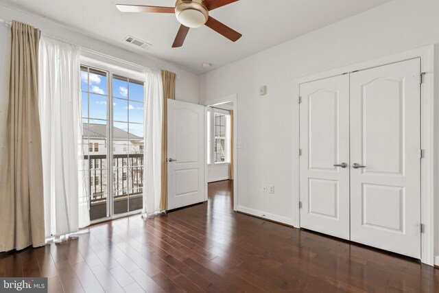 400 Cameron Station Blvd Unit 417, Alexandria, VA 22304 - unfurnished bedroom featuring access to outside, dark wood-type flooring, a closet, a ceiling fan, and baseboards