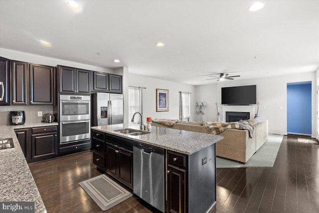 2121 River Heritage Blvd, Dumfries, VA 22026 - kitchen featuring stainless steel appliances, a sink, ceiling fan, light stone counters, and an island with sink