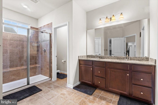 2121 River Heritage Blvd, Dumfries, VA 22026 - bathroom with a shower stall, double vanity, tile patterned floors, and baseboards