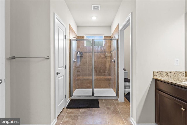 2121 River Heritage Blvd, Dumfries, VA 22026 - bathroom featuring a stall shower, vanity, baseboards, toilet, and tile patterned floors