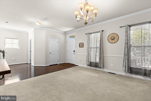 2121 River Heritage Blvd, Dumfries, VA 22026 - carpeted foyer featuring a chandelier, ornamental molding, baseboards, and wood finished floors